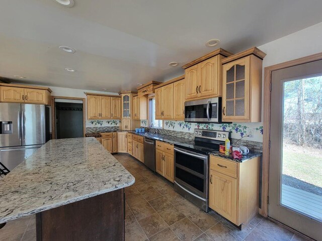 N14341 Fairground Ave, Owen, WI 54460 - kitchen with glass insert cabinets, stone countertops, stainless steel appliances, and a kitchen island