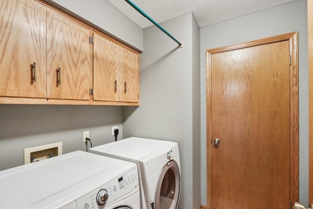 laundry area with washing machine and dryer and cabinet space