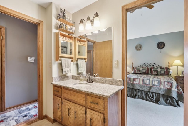 bathroom featuring ensuite bath and vanity