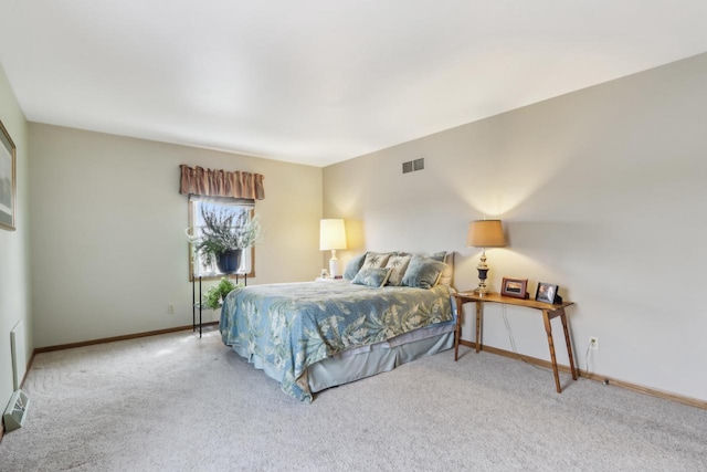 carpeted bedroom featuring baseboards and visible vents