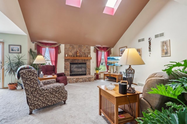 living area with high vaulted ceiling, a stone fireplace, visible vents, and carpet