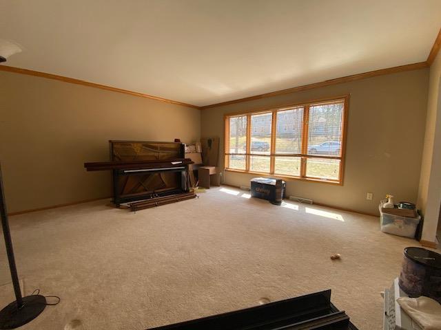 interior space with baseboards and ornamental molding