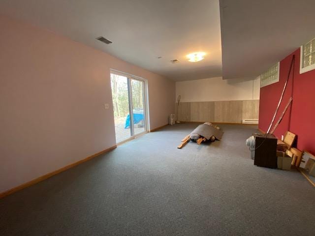 carpeted empty room featuring visible vents