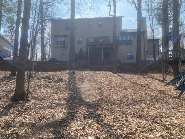 back of property with a balcony and a deck