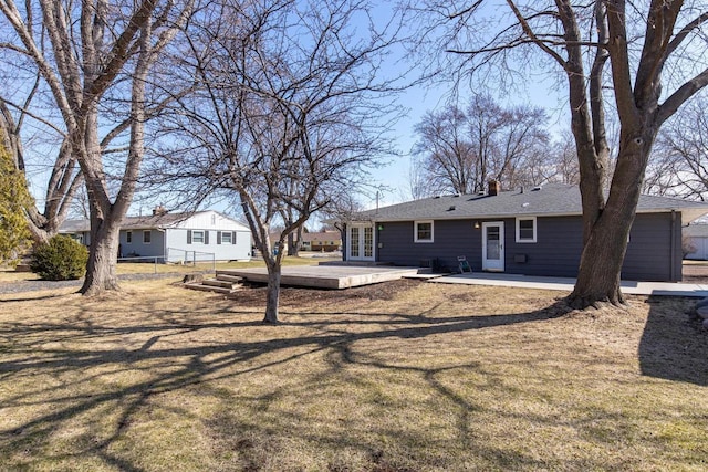 back of house featuring french doors, a lawn, and a patio