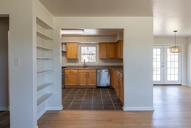 kitchen featuring open shelves, a sink, built in features, baseboards, and appliances with stainless steel finishes