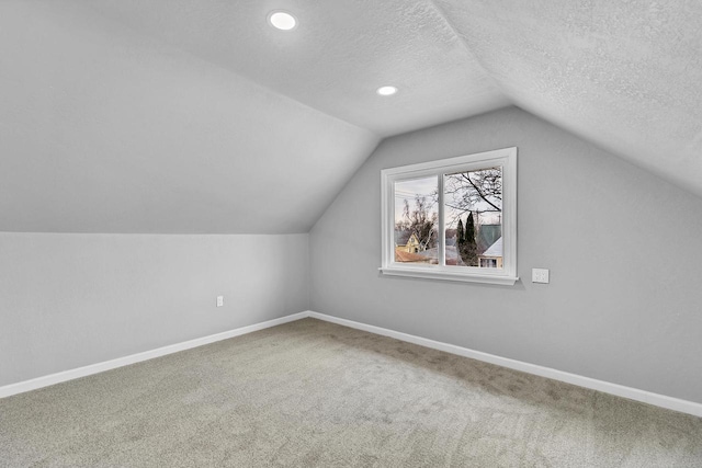 6824 W Hayes Ave, West Allis, WI 53219 - additional living space featuring baseboards, a textured ceiling, and carpet
