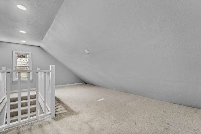 6824 W Hayes Ave, West Allis, WI 53219 - additional living space with recessed lighting, vaulted ceiling, carpet floors, and a textured ceiling