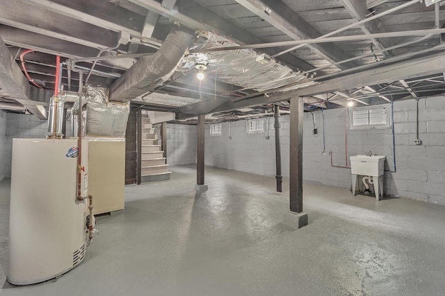 6824 W Hayes Ave, West Allis, WI 53219 - below grade area with stairway, a sink, and gas water heater