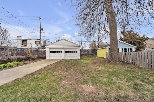 6824 W Hayes Ave, West Allis, WI 53219 - view of yard featuring an outdoor structure, fence, and a detached garage