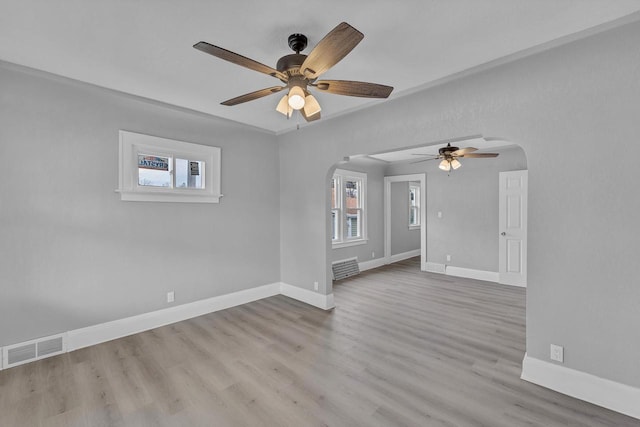 6824 W Hayes Ave, West Allis, WI 53219 - empty room featuring baseboards, a ceiling fan, visible vents, and arched walkways