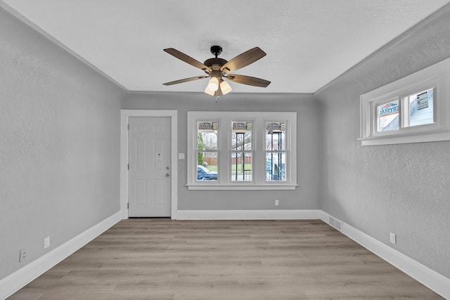 6824 W Hayes Ave, West Allis, WI 53219 - foyer entrance featuring a ceiling fan, a textured wall, visible vents, and plenty of natural light