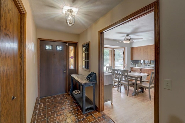 504 Lake St, Mount Horeb, WI 53572 - foyer featuring a ceiling fan, brick patterned floors, and baseboards