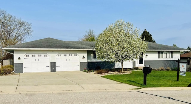 504 Lake St, Mount Horeb, WI 53572 - view of front of house with an attached garage, driveway, and a front lawn