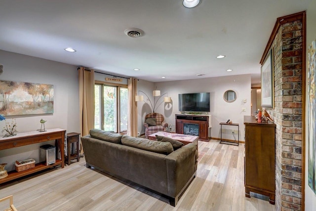 504 Lake St, Mount Horeb, WI 53572 - living room with a glass covered fireplace, light wood-style flooring, recessed lighting, and baseboards