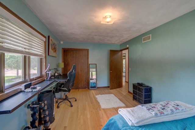504 Lake St, Mount Horeb, WI 53572 - bedroom featuring wood finished floors, an office area, and baseboards