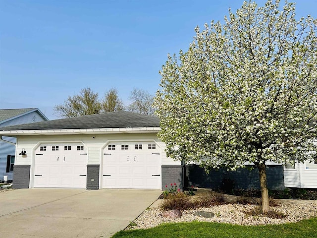 504 Lake St, Mount Horeb, WI 53572 - view of side of home with driveway, brick siding, and a shingled roof