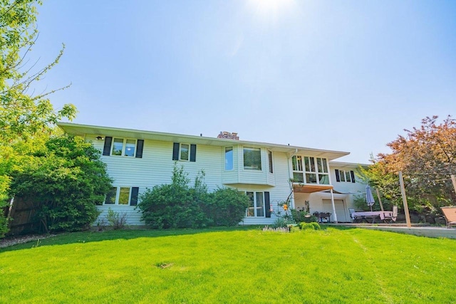 504 Lake St, Mount Horeb, WI 53572 - rear view of house featuring a lawn and a chimney