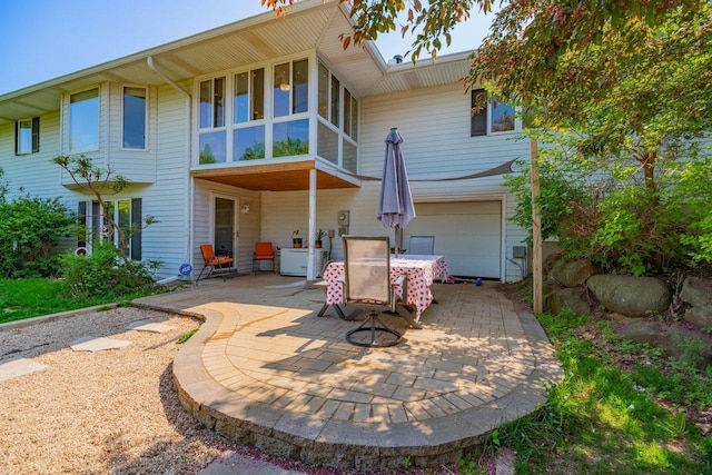 504 Lake St, Mount Horeb, WI 53572 - back of house featuring a patio area, outdoor dining space, and a garage
