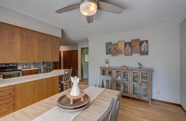 504 Lake St, Mount Horeb, WI 53572 - dining space with a ceiling fan, light wood-type flooring, and baseboards