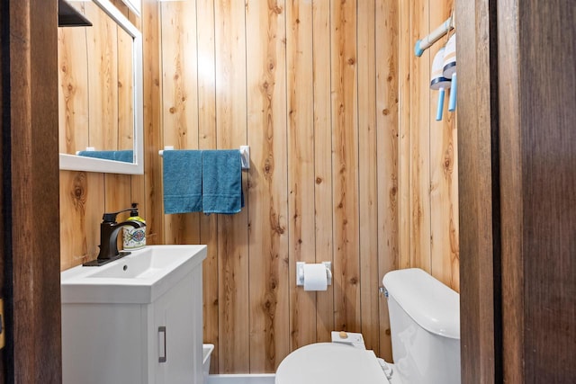 N4823 Peppler Ln, Wild Rose, WI 54984 - bathroom featuring toilet, wood walls, and vanity