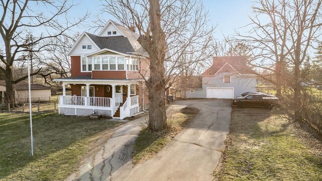 607 Jefferson Ave, Omro, WI 54963 - victorian house featuring driveway, a front yard, and covered porch