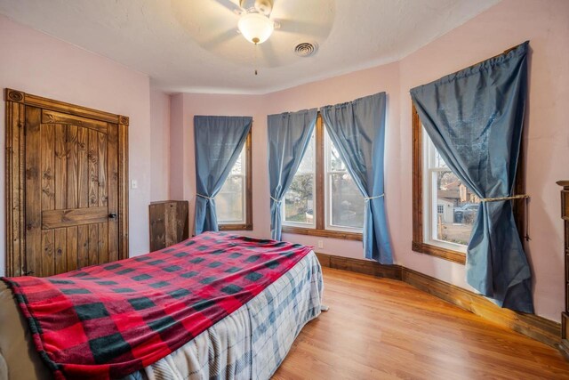 607 Jefferson Ave, Omro, WI 54963 - bedroom with a ceiling fan, light wood finished floors, and visible vents