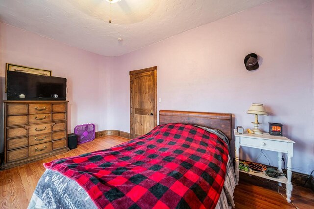 607 Jefferson Ave, Omro, WI 54963 - bedroom featuring ceiling fan, baseboards, and wood finished floors