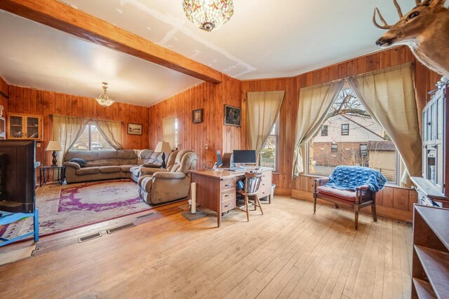 607 Jefferson Ave, Omro, WI 54963 - living area featuring a chandelier, hardwood / wood-style floors, beam ceiling, and wood walls