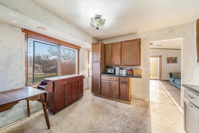 607 Jefferson Ave, Omro, WI 54963 - kitchen featuring brown cabinetry and dark countertops