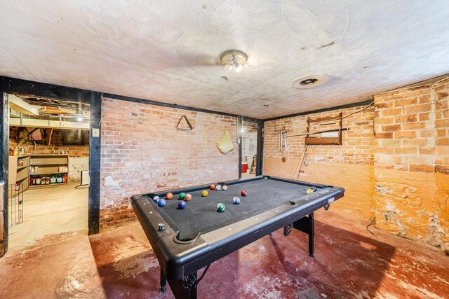 607 Jefferson Ave, Omro, WI 54963 - game room featuring brick wall, pool table, and concrete floors