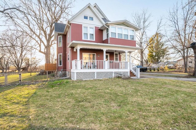 607 Jefferson Ave, Omro, WI 54963 - view of front facade featuring a front lawn, fence, and a porch