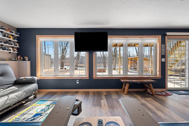 interior space featuring baseboards and wood finished floors