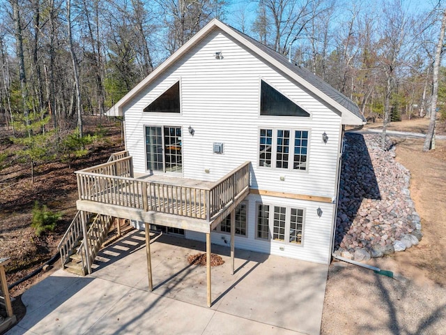 back of property featuring a wooden deck, stairway, and a patio area