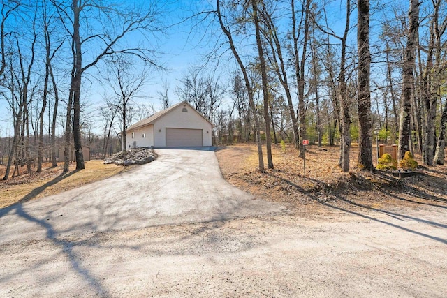 view of side of home featuring an outdoor structure and a garage