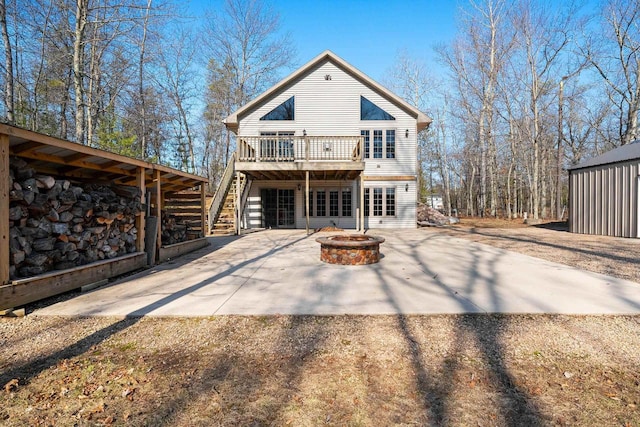 back of property featuring a patio, an outdoor fire pit, stairs, and a deck