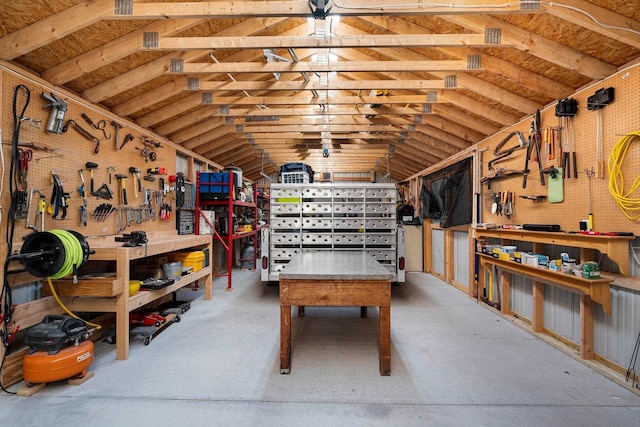 game room featuring lofted ceiling and a workshop area