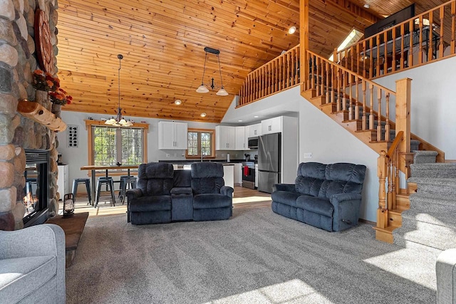 living room with carpet floors, high vaulted ceiling, stairway, wooden ceiling, and a fireplace
