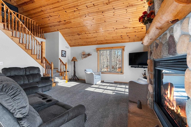 carpeted living area featuring wooden ceiling, baseboards, stairs, and a fireplace