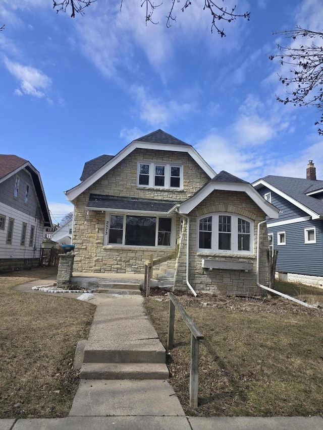 bungalow-style home with stone siding