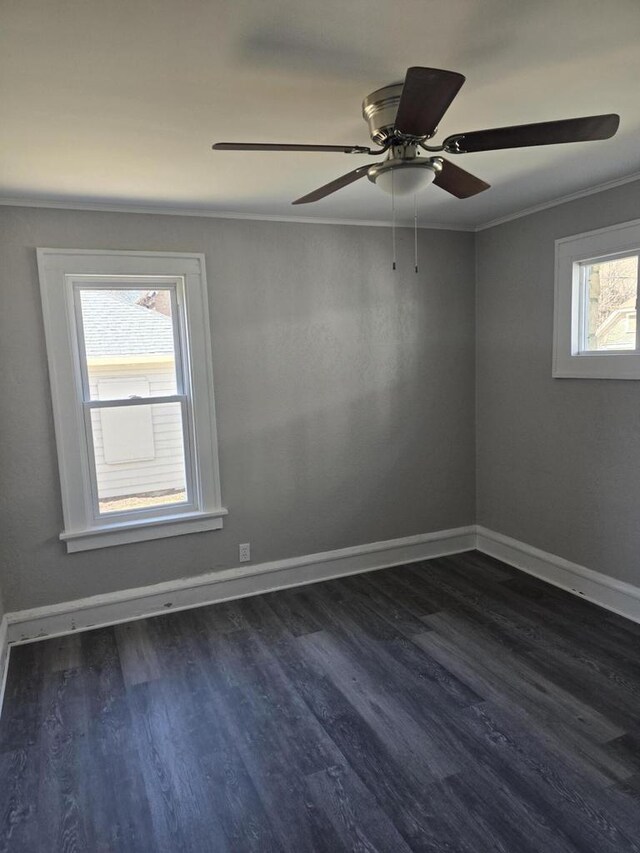 spare room with ceiling fan, baseboards, ornamental molding, and dark wood-style floors