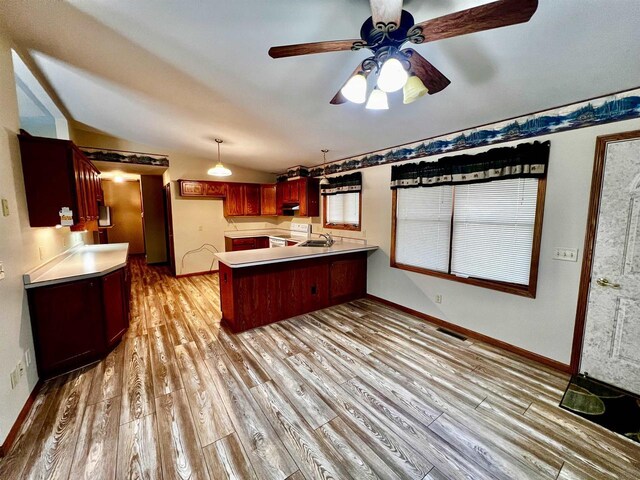 489 Sir Winston Trl, Nekoosa, WI 54457 - kitchen featuring a peninsula, light wood-type flooring, vaulted ceiling, white electric stove, and a ceiling fan