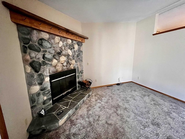 489 Sir Winston Trl, Nekoosa, WI 54457 - unfurnished living room with carpet floors, a stone fireplace, and baseboards