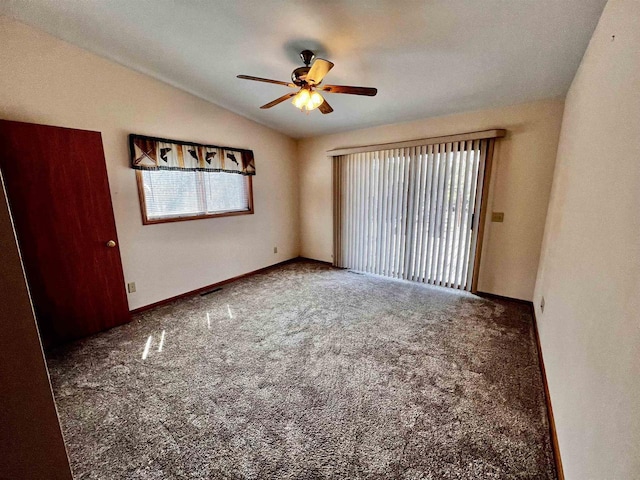 489 Sir Winston Trl, Nekoosa, WI 54457 - spare room with lofted ceiling, carpet floors, ceiling fan, and baseboards