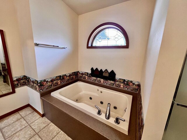 489 Sir Winston Trl, Nekoosa, WI 54457 - bathroom featuring a tub with jets, tile patterned floors, and baseboards