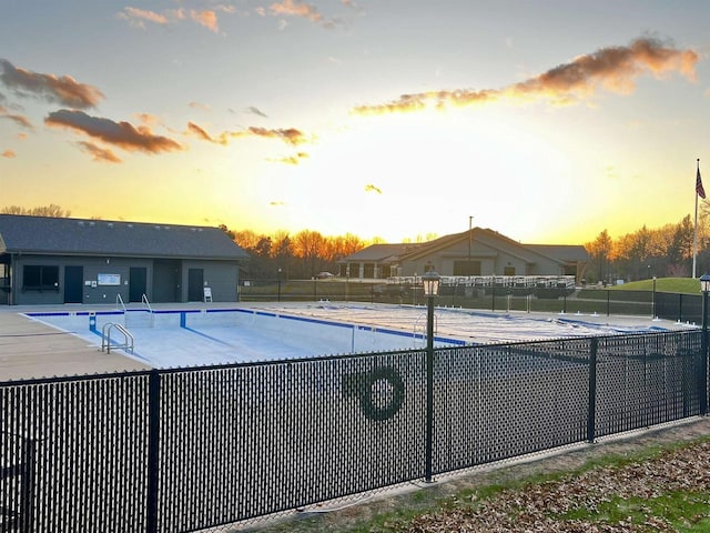 489 Sir Winston Trl, Nekoosa, WI 54457 - pool at dusk featuring a community pool and a patio area