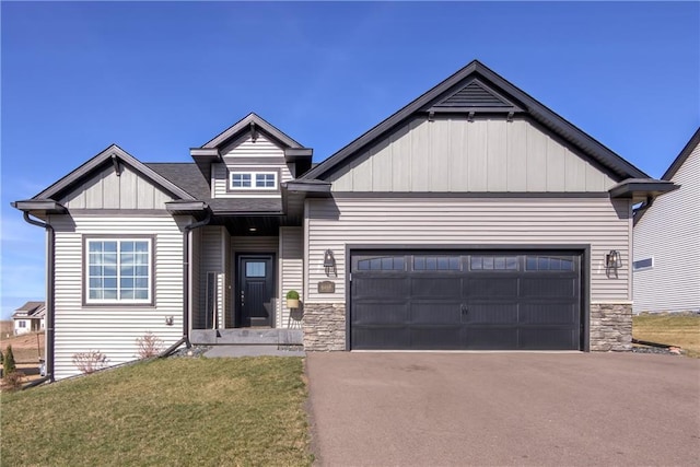 6468 Aspen Ridge Dr, Eau Claire, WI 54703 - craftsman house featuring aphalt driveway, board and batten siding, stone siding, a front yard, and a garage
