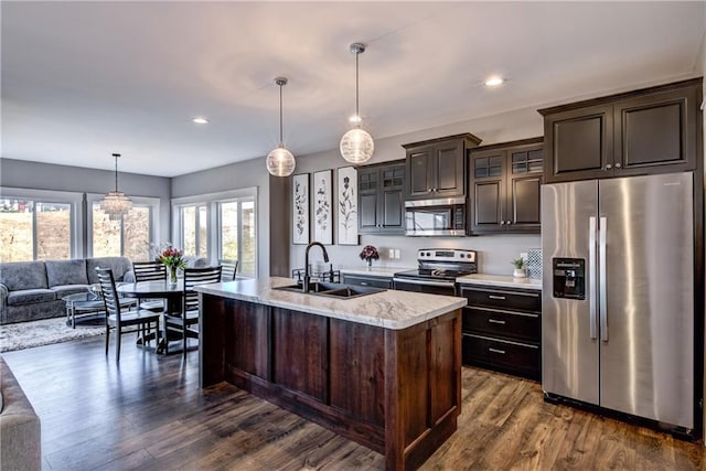 6468 Aspen Ridge Dr, Eau Claire, WI 54703 - kitchen featuring dark brown cabinets, open floor plan, stainless steel appliances, and a sink