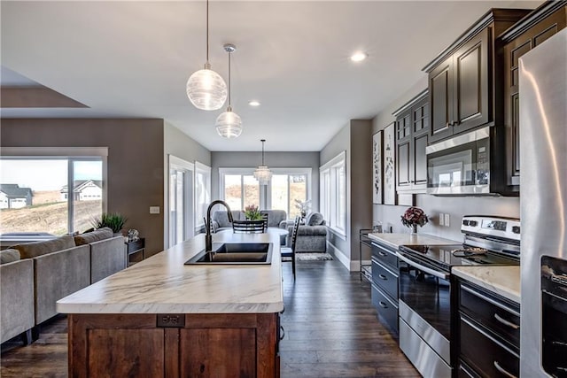6468 Aspen Ridge Dr, Eau Claire, WI 54703 - kitchen with open floor plan, stainless steel appliances, light countertops, and a sink