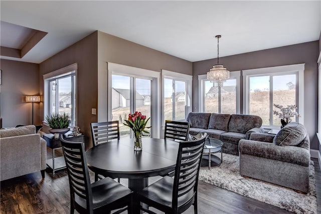 6468 Aspen Ridge Dr, Eau Claire, WI 54703 - dining area featuring an inviting chandelier, dark wood-style floors, and a wealth of natural light